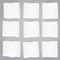 Pieces of torn gray note paper with adhesive tape