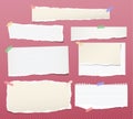 Pieces of torn white lined and blank note, notebook paper strips for text stuck with colorful sticky tape on squared red Royalty Free Stock Photo