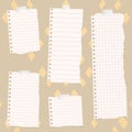 Pieces of torn white lined and squared notebook paper on colorful fabric pattern