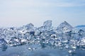 Pieces of transparent blue ice on the mirror surface of frozen Baikal Lake Royalty Free Stock Photo