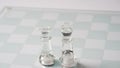 Pieces of transparent chess, king and queen. Transparent chess figures on chessboard Royalty Free Stock Photo