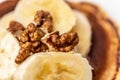 Pieces of walnuts and slices of bananas close up