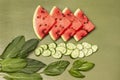 Pieces of watermelon, chopped cucumber and basil leaves