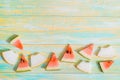 Pieces of watermelon and melon. Bright toy pineapplen on blue and yellow old wooden background. Summer concept. Flat lay, top view