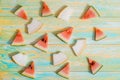 Pieces of watermelon and melon. Bright toy pineapplen on blue and yellow old wooden background. Summer concept. Flat lay, top view