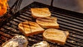 Pieces of white bread are grilling on the open fire outside Royalty Free Stock Photo