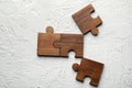 Pieces of wooden puzzle on white textured background Royalty Free Stock Photo