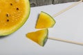 Pieces of yellow watermelon on sticks