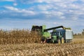 Combine harvester corn and discharge it into the trailer Royalty Free Stock Photo
