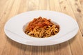 Piedmontese tajarin, Italian tagliolini topped with tomato and meat sauce in white plate Royalty Free Stock Photo