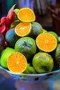 Piel of Asian exotic fruits on the plate. Apples, oranges, mangos, dragon and passion fruits