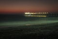 Pier on the Atlantic Ocean in Swakompund, Namibia. Beautiful sunset with a bright sky and soft gentle water Royalty Free Stock Photo