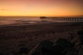 Pier on the Atlantic Ocean in Swakompund, Namibia. Beautiful sunset with a bright sky and soft gentle water Royalty Free Stock Photo