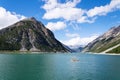 Pier with benches, Livigno lake with Corno Brusadella Mountain, Italy