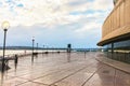 The pier at Bennelong Point in Circular Quay in Sydney Austraia - a woman runs beside the Opera House on a rainy morning