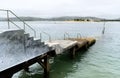 Pier built with cement and shaped like a ladder that enters the sea. Concept of destination, path, introduction