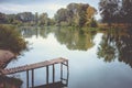 Pier on a calm river in the summer. Wooden pier bridge Royalty Free Stock Photo