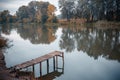 Pier on a calm river in the summer. Wooden pier bridge Royalty Free Stock Photo