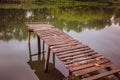 Pier on a calm river in the summer. Wooden pier bridge Royalty Free Stock Photo