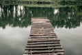 Pier on a calm river in the summer. Wooden pier bridge Royalty Free Stock Photo