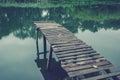 Pier on a calm river in the summer. Wooden pier bridge Royalty Free Stock Photo