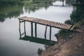 Pier on a calm river in the summer. Wooden pier bridge Royalty Free Stock Photo