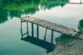 Pier on a calm river in the summer. Wooden pier bridge Royalty Free Stock Photo