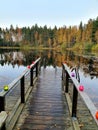 Pier and candles on the lake in the autumn forest Royalty Free Stock Photo