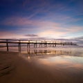 Pier at dawn with interesting reflections Royalty Free Stock Photo