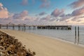 Pier and Empty Beach Beyond Seawall Royalty Free Stock Photo
