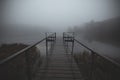 Pier on a foggy morning lake with mystical fog Royalty Free Stock Photo