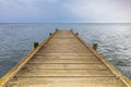 Pier that goes into the sea with the horizon in the background. End of summer concept Royalty Free Stock Photo