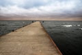 Pier going out into the Bay Cape Flotski under stormy skies.