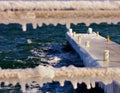 Pier in the ice with defocused frozen fence