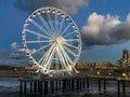 The pier jetty of scheveningen at night with the ferris wheel lighted up and view on the town Royalty Free Stock Photo