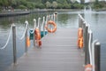 The pier on the lake. Bridge by the water. Lifebuoys on the pier