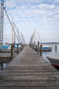 Pier on the lake with parked and covered sailboats in the morning Royalty Free Stock Photo