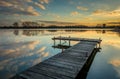 Pier on the lake, reflection of clouds in the water after sunset Royalty Free Stock Photo