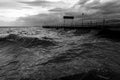 Pier on a lake with stormy weather and big waves Royalty Free Stock Photo