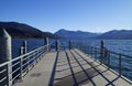 a pier on lake Tegernsee in Bavaria with the wintery Alps in the background on a sunny December day (Bavaria in Germany) Royalty Free Stock Photo