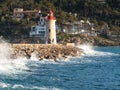 Pier with lighthouse and group of funny young people Royalty Free Stock Photo