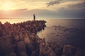 Pier with lighthouse at sunset Royalty Free Stock Photo