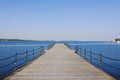 The pier near beach against blue sky in sunny day. Adriatic coast and sea in Slovenia. Holiday and travel concept Royalty Free Stock Photo