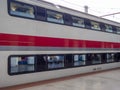 At the pier near the departing train. Passenger transportation