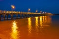 Pier at night with yellow lights on a background of blue sky Royalty Free Stock Photo