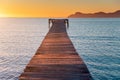 Pier in orange sunrise colors. Playa de Muro