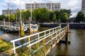 Pier over city river with sailboats, background, wallpaper. Royalty Free Stock Photo