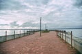 The pier overlooks the sea against the backdrop of a cloudy autu