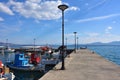 Pier in Paralia Politikon and small fishing boats, Greece