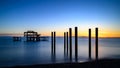 Pier poles at sunset near a fishing dock, extending into the ocean Royalty Free Stock Photo